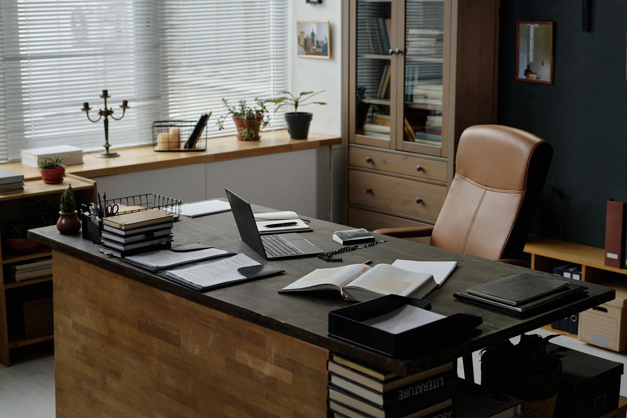 Organized office desk with laptop and work materials