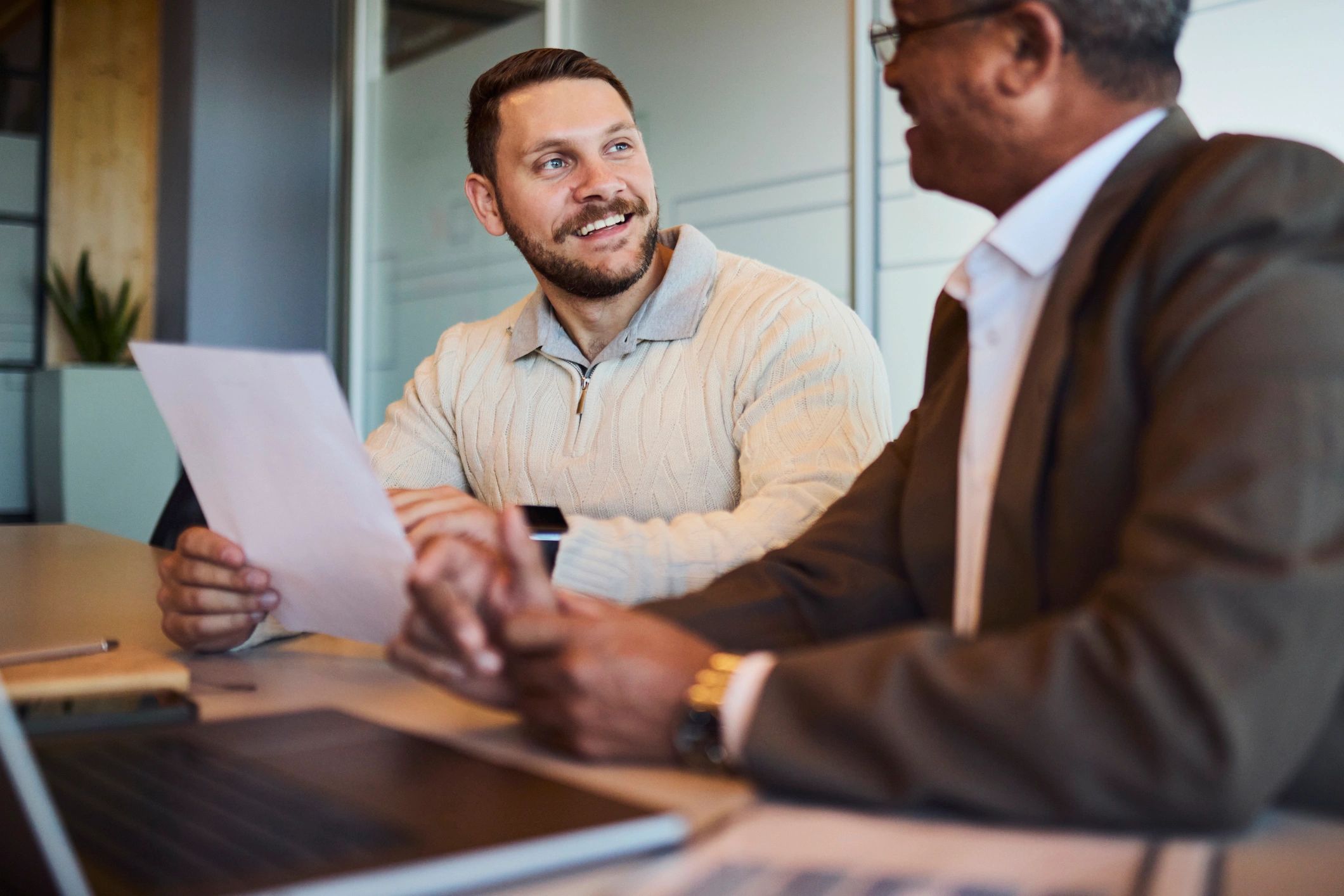 Business professionals reviewing paperwork together in an office